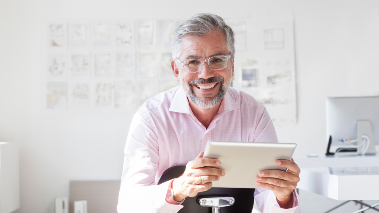 Provider smiling holding an iPad